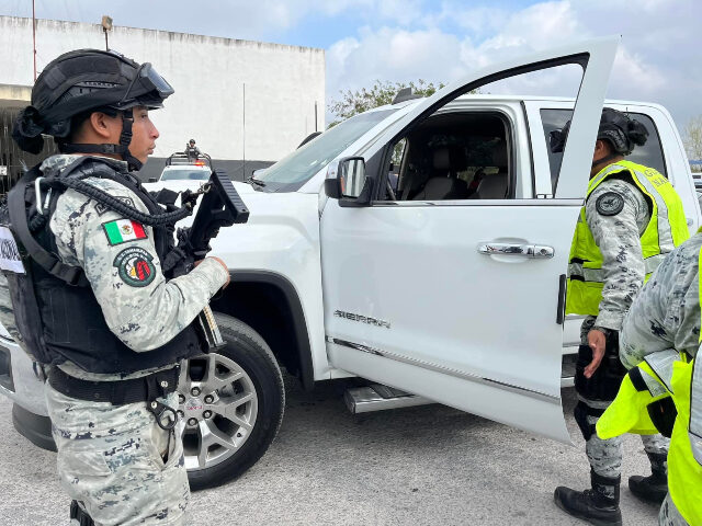 Mexican National Guardsmen inspect vehicles in Matamoros. (Credit: Breitbart News Foundati